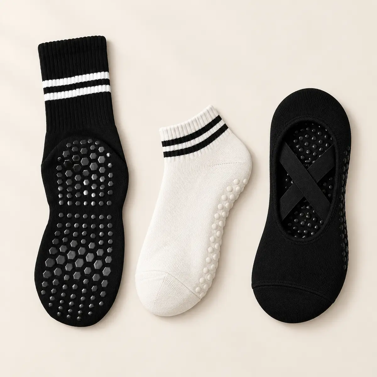 The three PIVELYA styles side by side, flat lay: black crew, off-white ankle and black ballet grip socks
